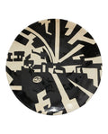 A decorative plate with a geometric minimalist design in black and beige colors, with a distinctive art deco aesthetic.