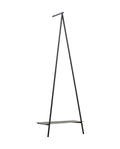 Black metal coat rack with a shelf on a white background