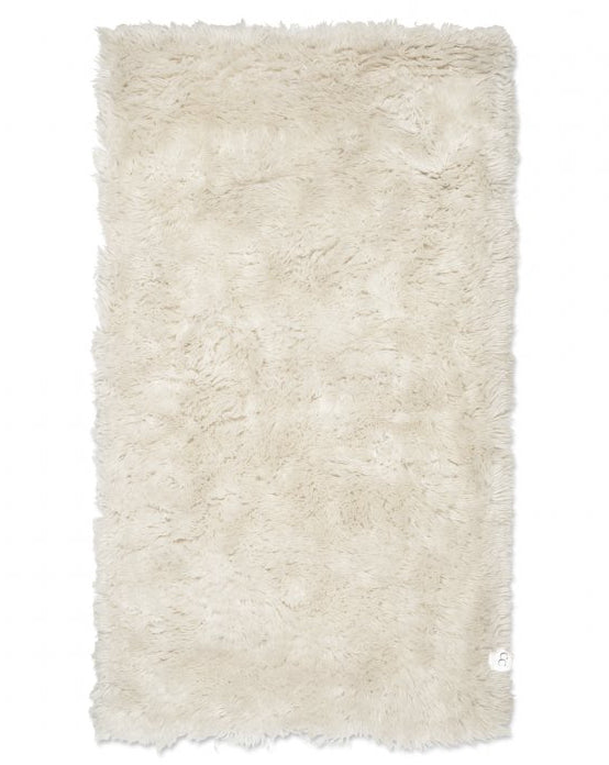 Beige shaggy rug on a white background