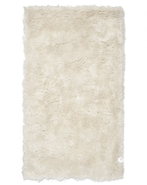 Beige shaggy rug on a white background