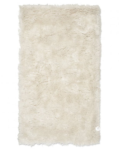 Beige shaggy rug on a white background