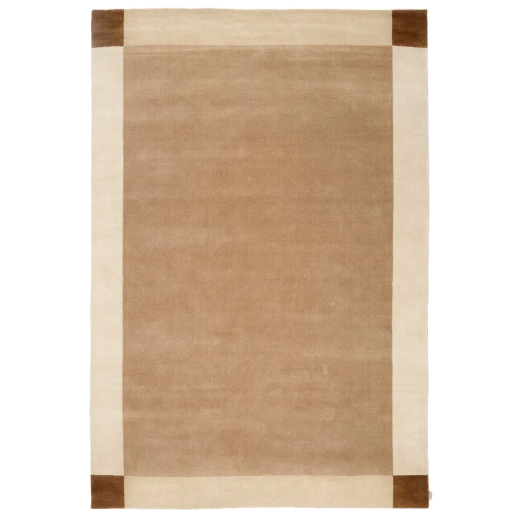 A rectangular area rug with a warm tan center, bordered by an off-white stripe and dark brown corner blocks, shown flat against a white background.