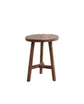 A rustic, round, wooden stool made from recycled wood with a natural finish.
