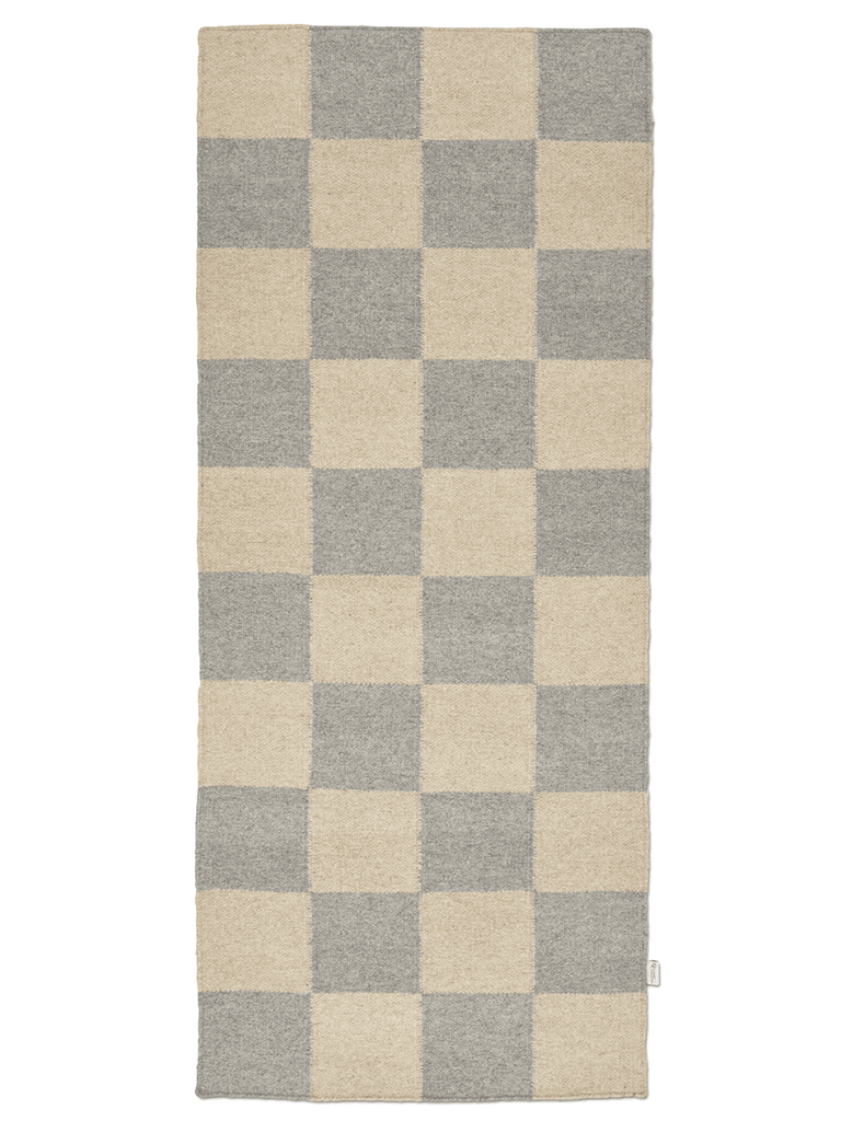 Checkered rug with beige and gray squares on a white background