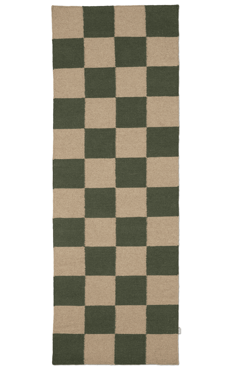 Checkered rug with green and beige squares on a white background