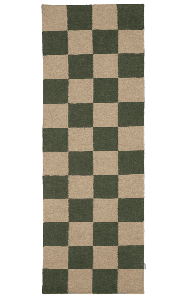 Checkered rug with green and beige squares on a white background