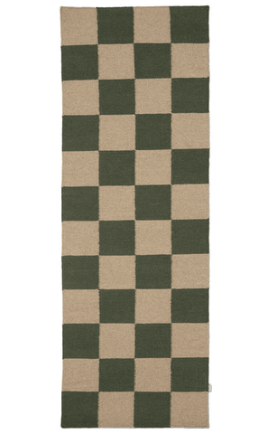 Checkered rug with green and beige squares on a white background