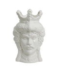 A white ceramic vase with a classical design, featuring a figure with a crown on top.
