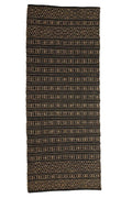 Patterned rug with geometric design on a white background